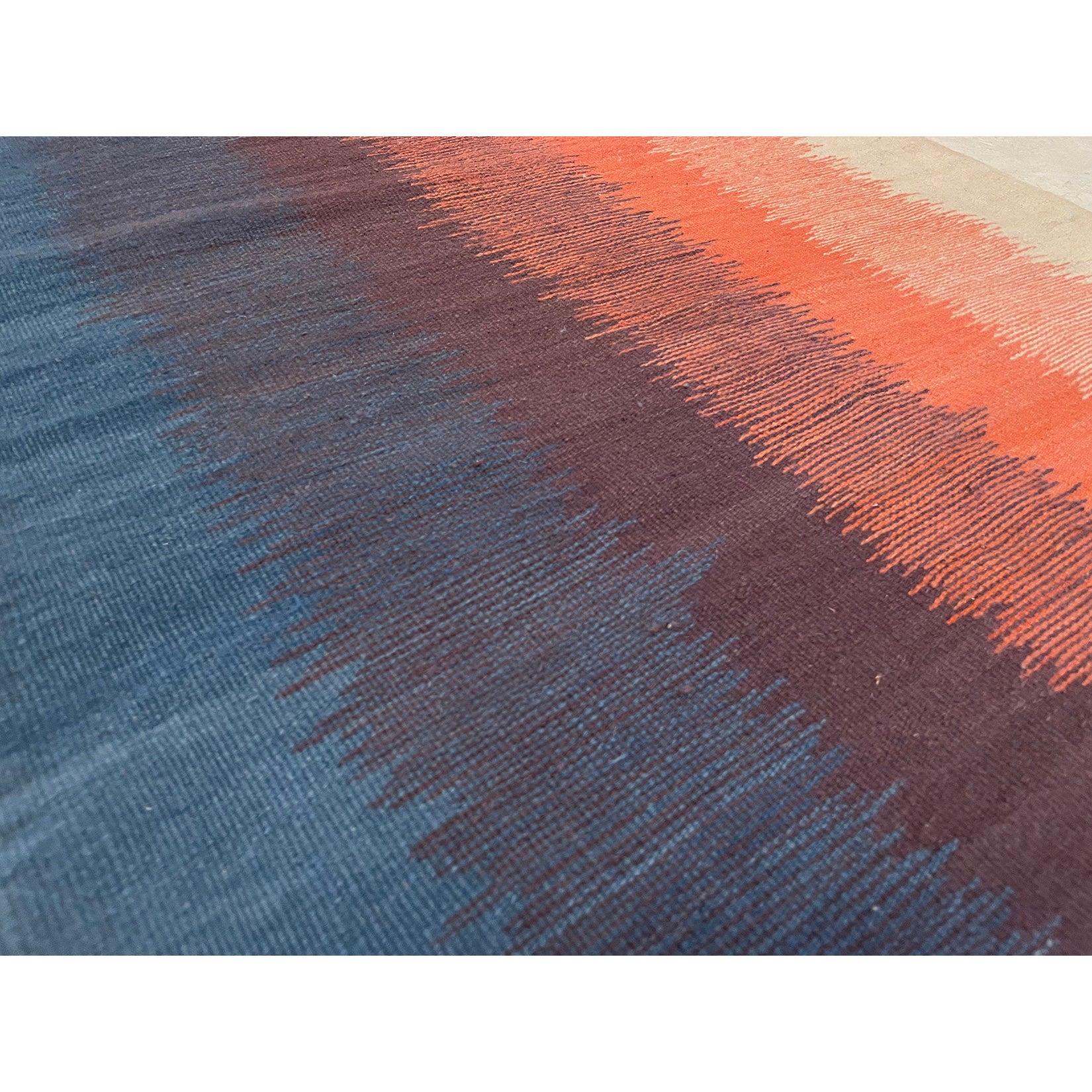 Closeup shot of this Moroccan runner rug with blue purple orange and cream vertical bands of color