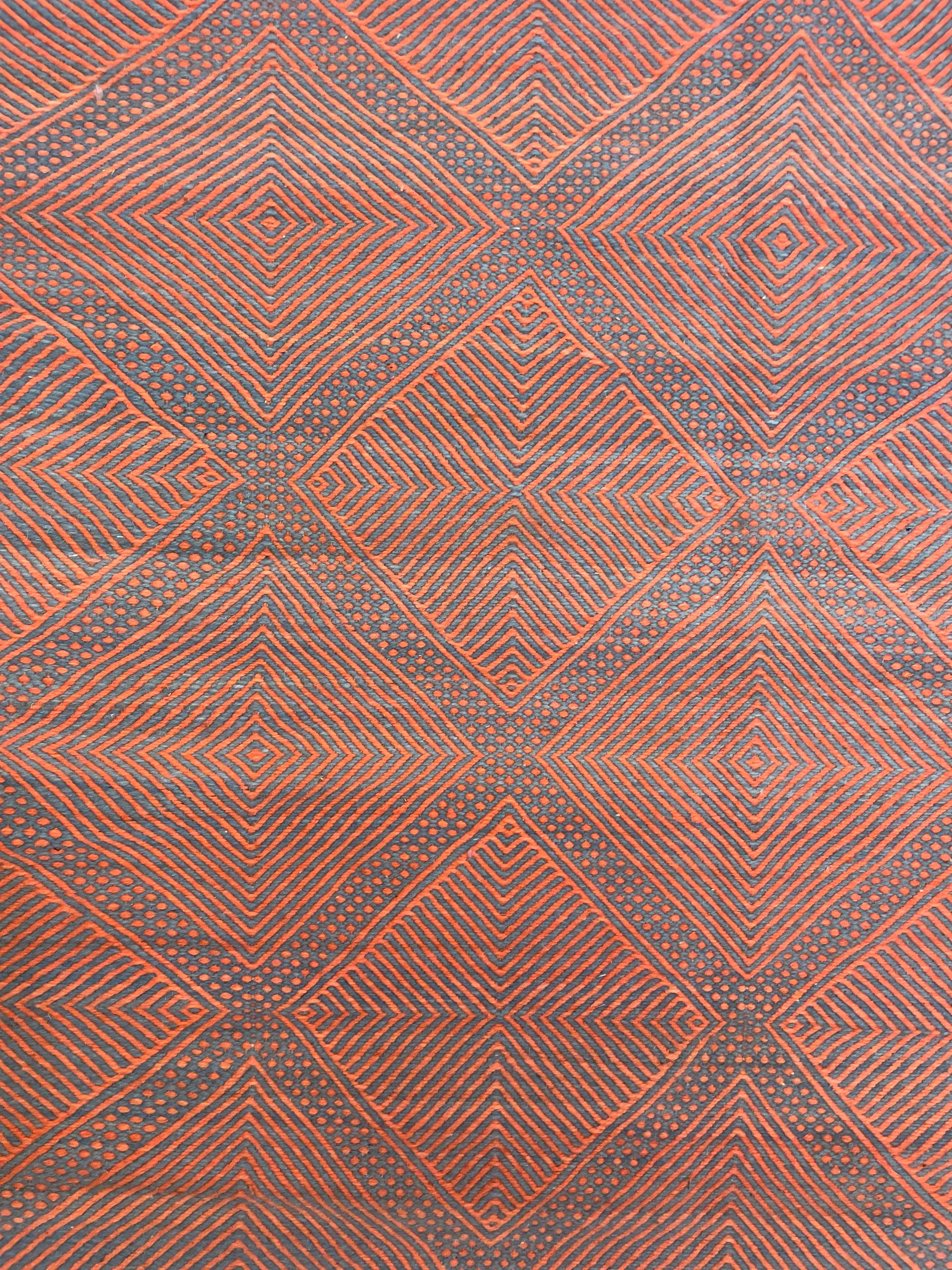 Detail of Zanafi weaving featuring repetitive geometric diamond shapes in pink and denim blue  | Kantara: Moroccan Rugs in Los Angeles