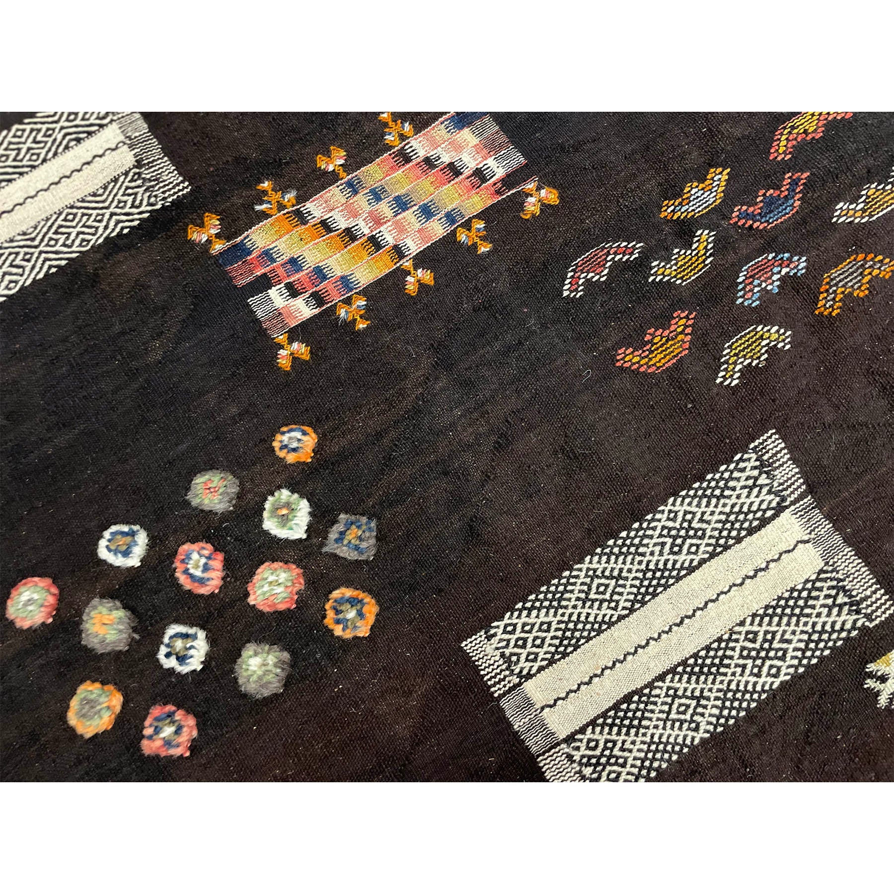 One-of-a-kind dark Moroccan rug with colorful details - Kantara | Moroccan Rugs