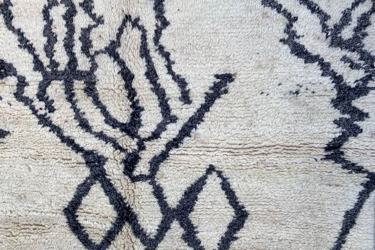 Detail of modern Moroccan Azilal white rug with abstract black designs