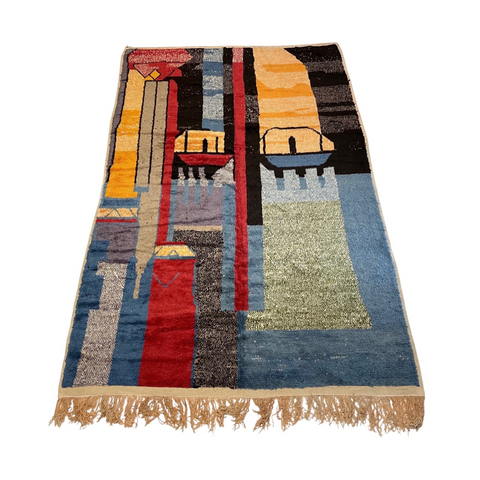 blue, red, yellow bold designs on large low pile moroccan rug designed for a nursery