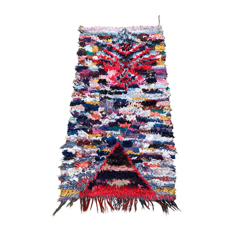 Moroccan boucherouite rag rug made with colorful tufted cotton in traditional Berber rug style