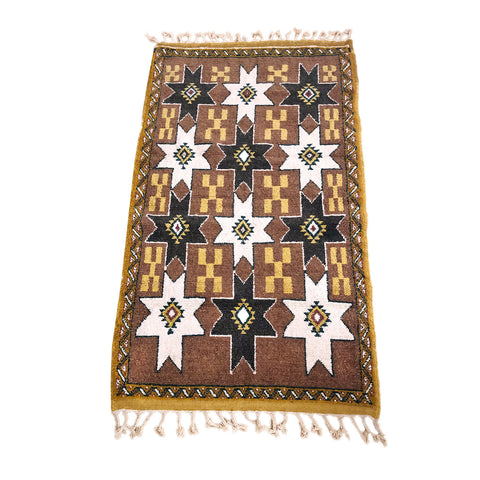 Brown Moroccan rug with tribal motifs