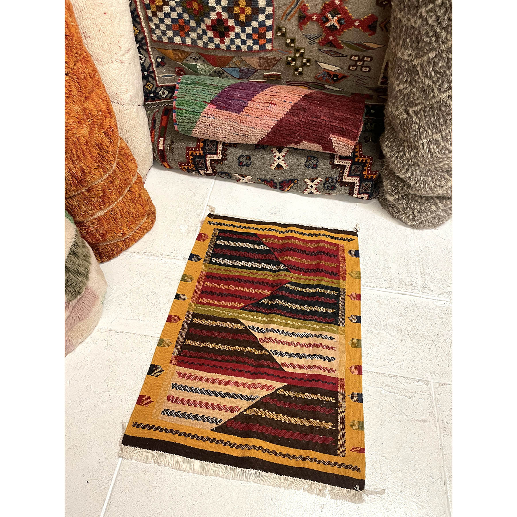 https://kantararugs.com/cdn/shop/files/R811.Detail.5.small-yellow-kharita-Moroccan-throw-rug-in-kantara-rugs-los-angeles-showroom.jpg?v=1684520369