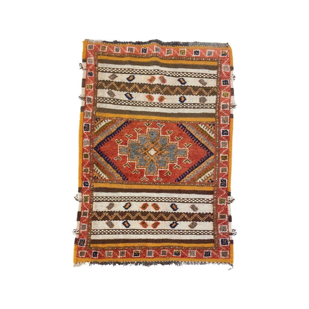 https://kantararugs.com/cdn/shop/files/R812.Hero.small-glaoui-throw-rug-with-center-red-medallion-and-yellow-brown-and-white-bands.jpg?v=1684520740