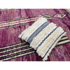 Moroccan wedding blanket pillow on top of purple abstract Moroccan rug made in High Atlas of Morocco by Kantara aritsans