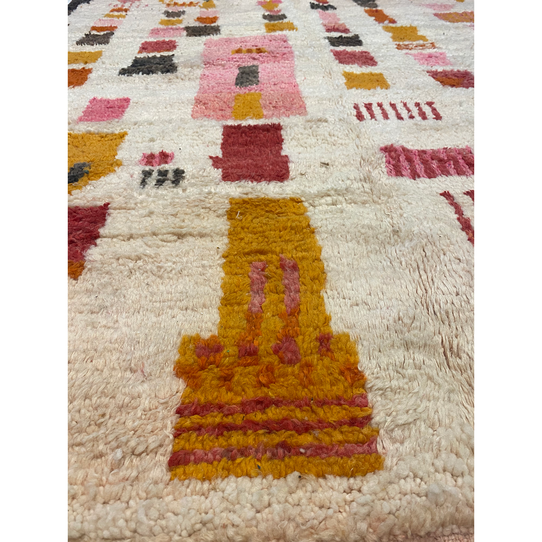 Mustard yellow and red and pink designs on Modern Berber rug