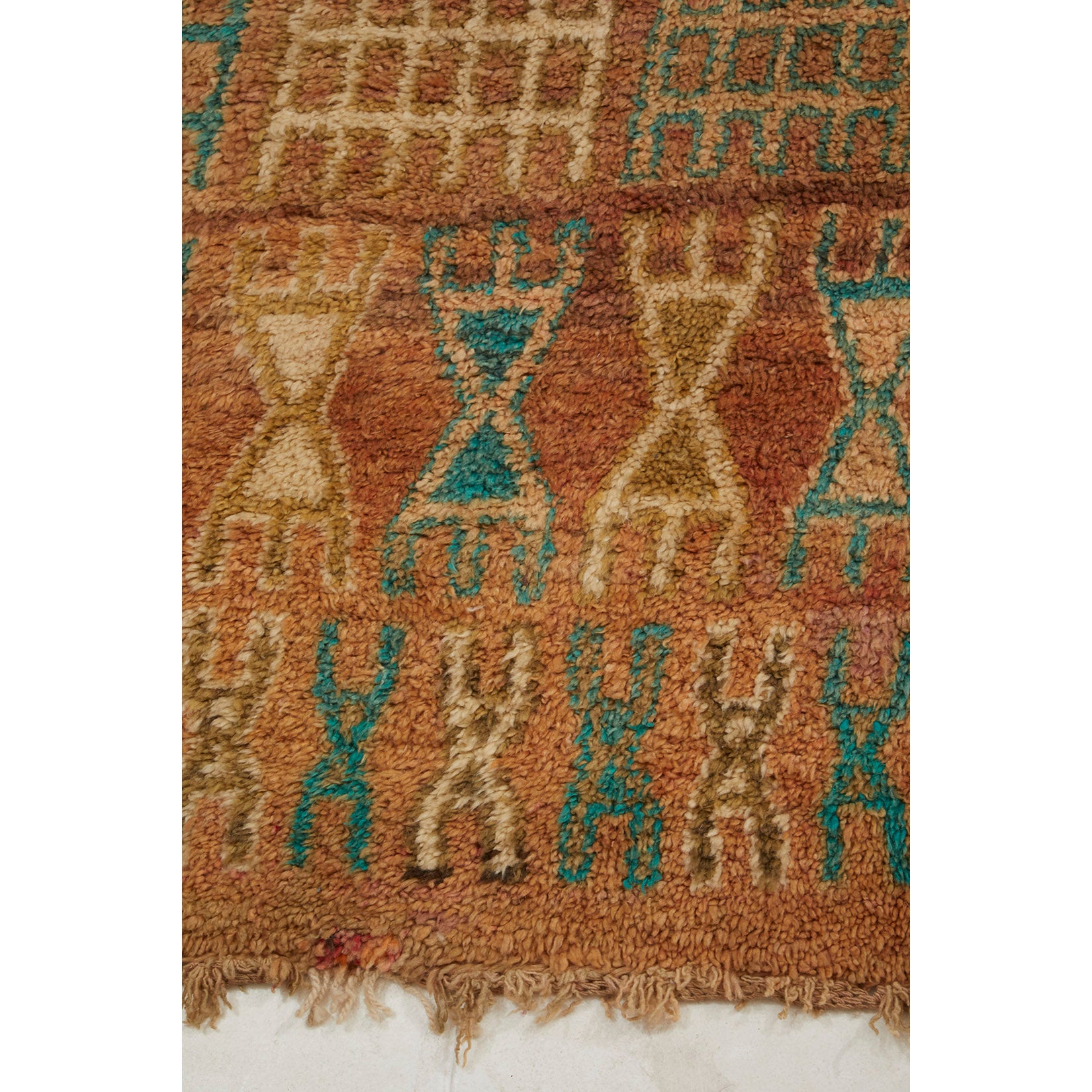 Rust colored Moroccan berber area rug with details in teal and white - Kantara | Moroccan Rugs