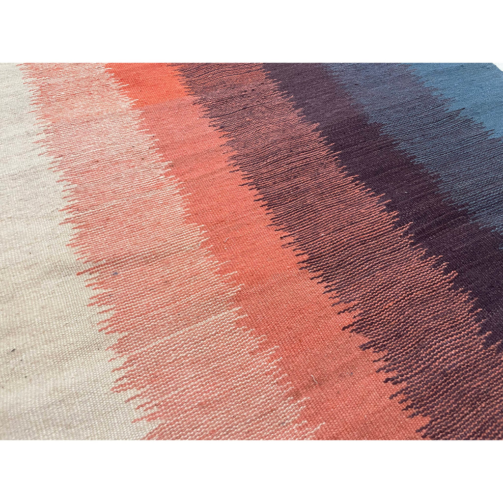 Closeup shot of this Moroccan runner rug with blue purple orange and cream vertical bands of color