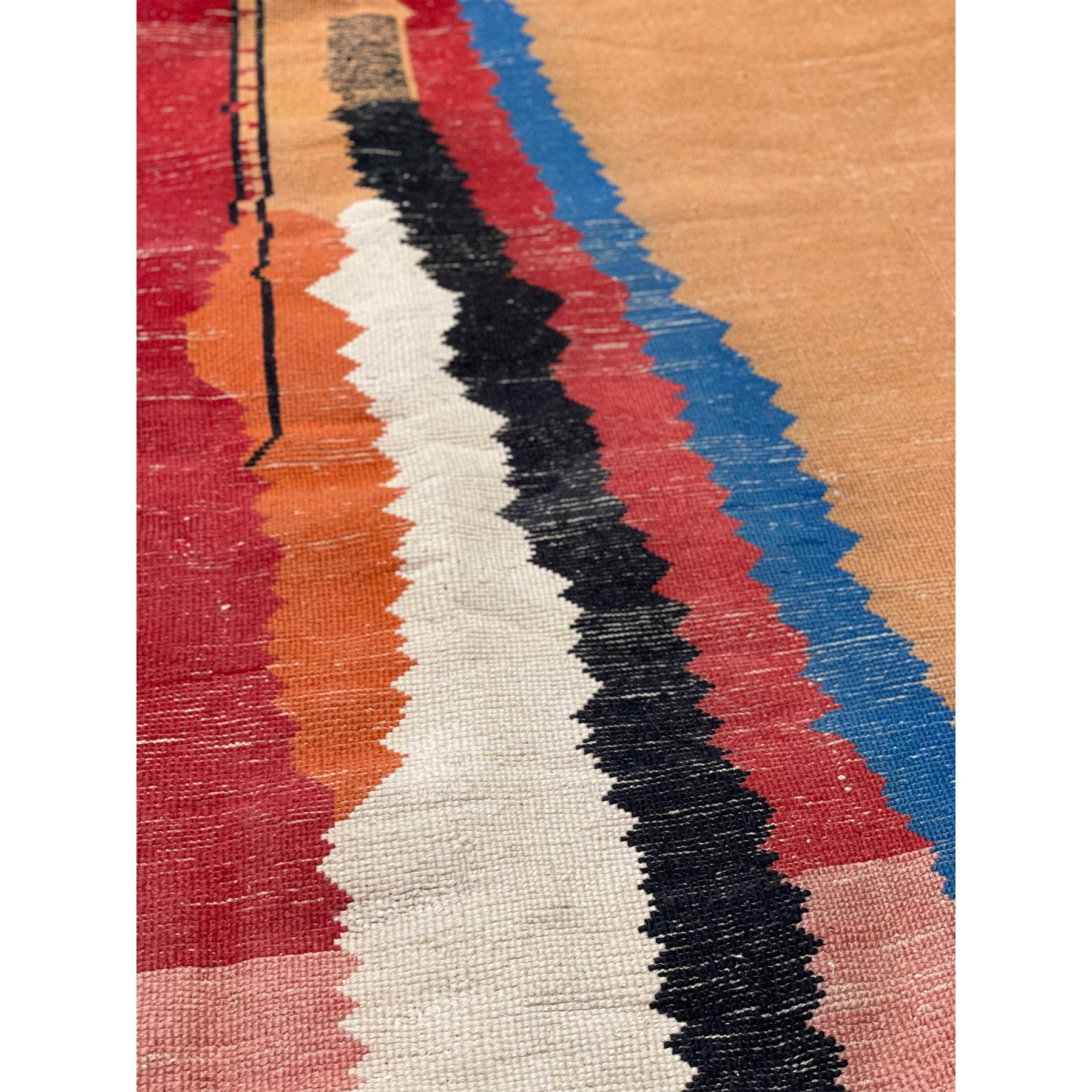 Handknotted oversized Moroccan rug in white wiith red, blue, and orange details - Kantara | Moroccan Rugs