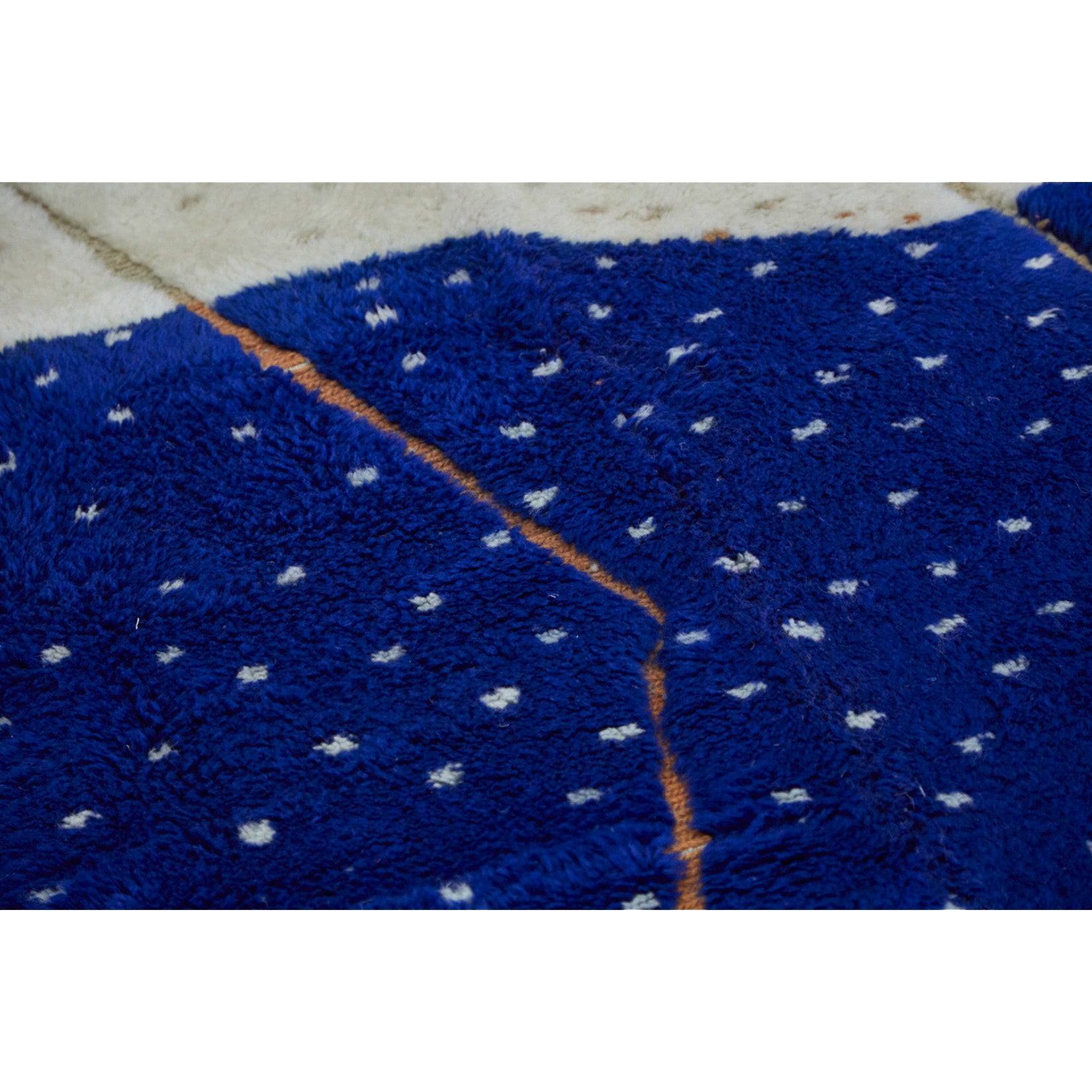 Colorful Moroccan bedroom rug in blue, white, and orange - Kantara | Moroccan Rugs