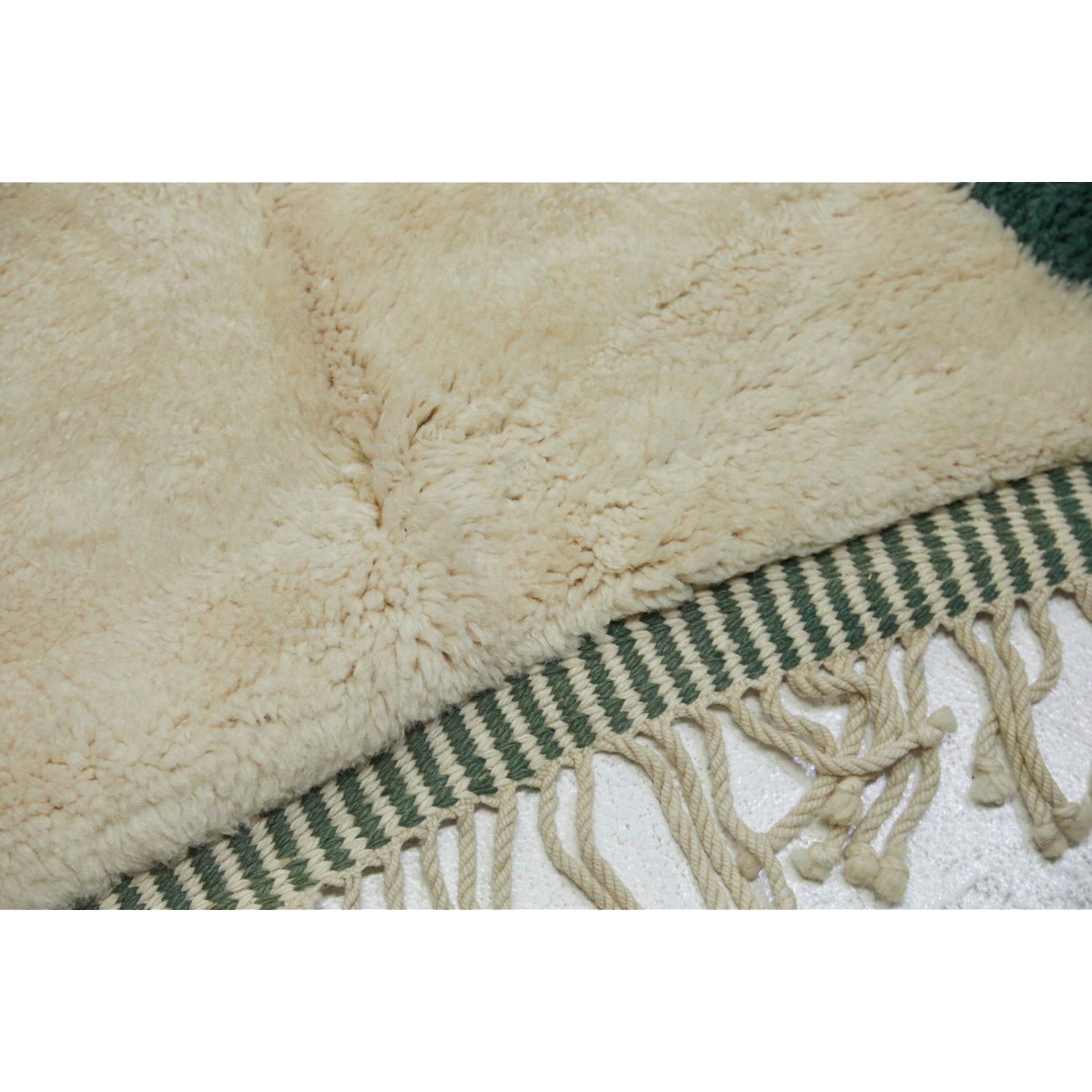 Braided fringe detail on oversized Moroccan rug in forest green and white- Kantara | Moroccan Rugs