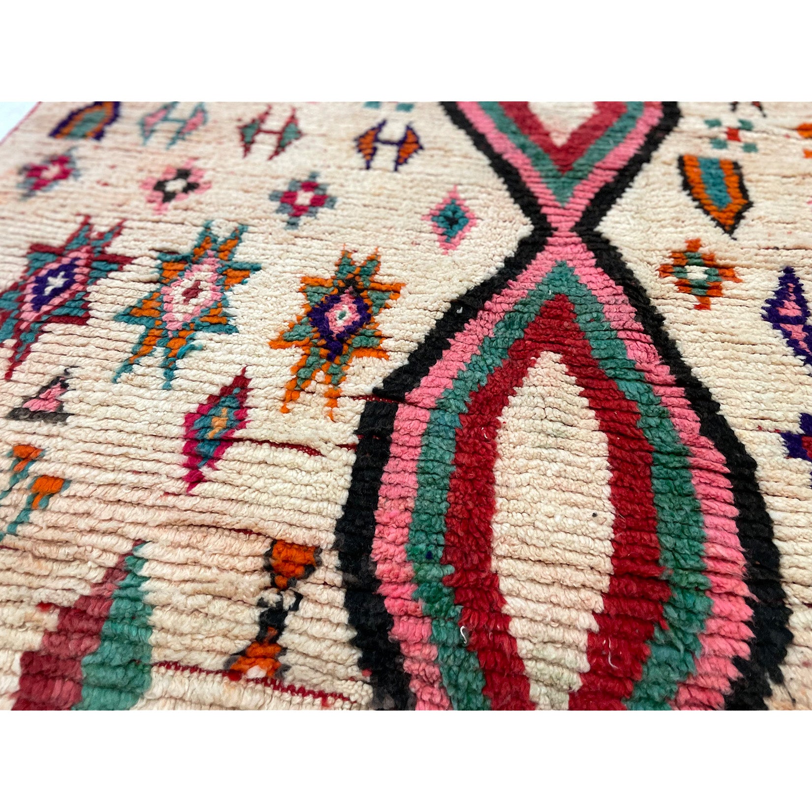 White Moroccan diamond rug with details in pink, blue, orange, green, and black - Kantara | Moroccan Rugs