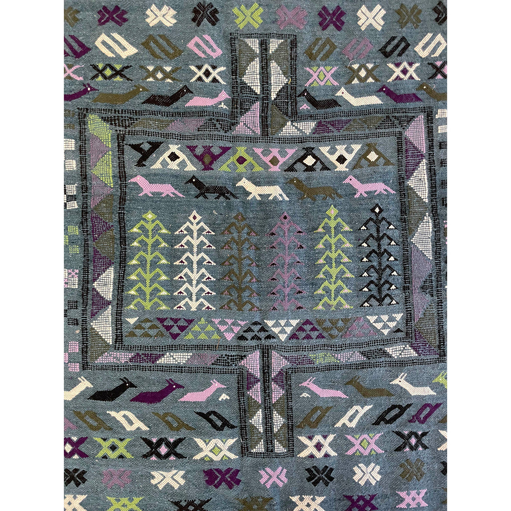 Traditional Moroccan Boujad rug woven with modern colors featuring animals and plant motifs  | Kantara Moroccan Rugs in Los Angeles