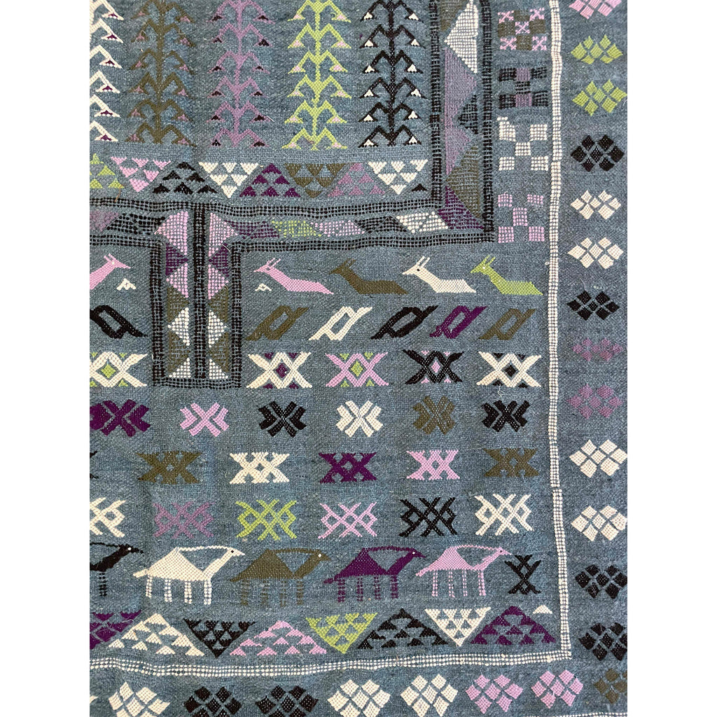 Moroccan flatweave kilim with a denim bluegrey base and colorful handwoven details from Boujad | Kantara Moroccan Rugs in Los Angeles