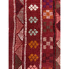 Close up of traditional border detail from Moroccan rug from the Middle Atlas Mountains on red background  | Kantara Moroccan Rugs in Los Angeles