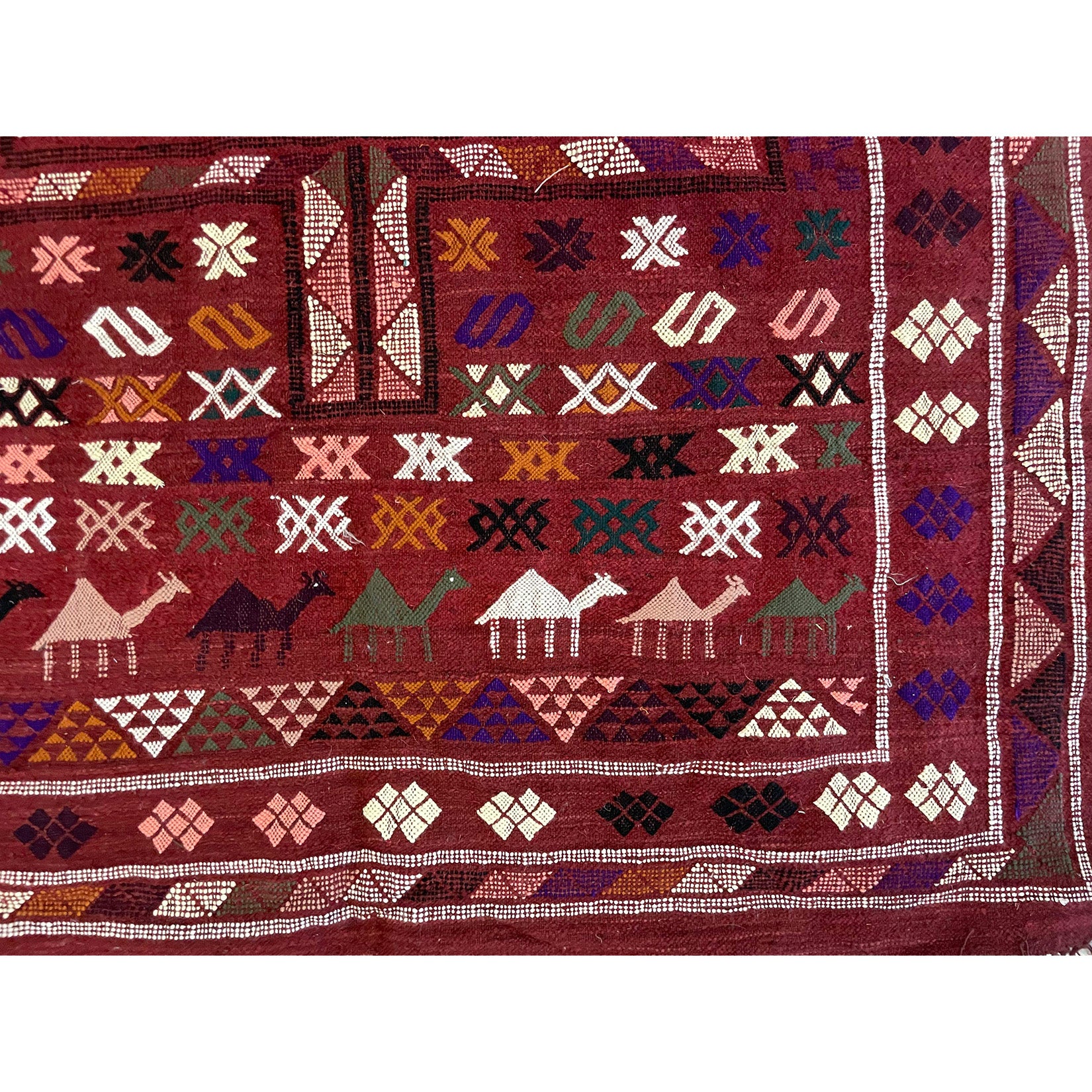Overhead view of traditional medium sized Moroccan berber kilim with line of camels in different colors and other geometric motifs  | Kantara Moroccan Rugs in Los Angeles