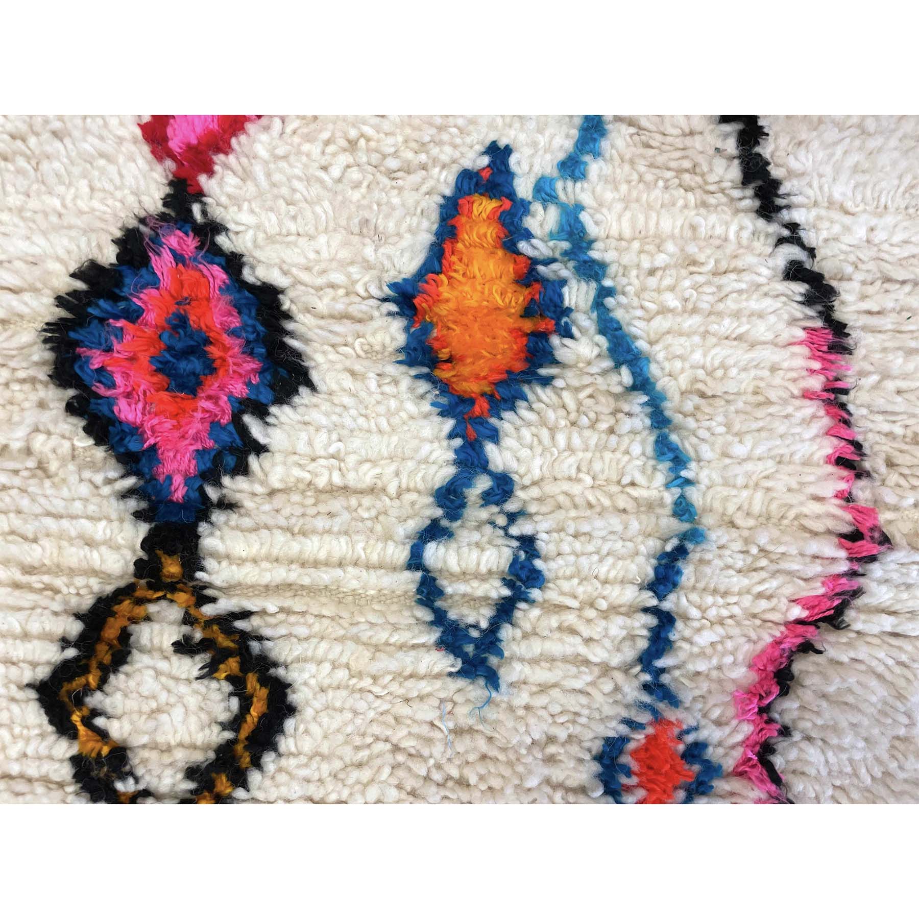 White Moroccan throw rug with details in blue, pink, orange, red, and black - Kantara | Moroccan Rugs