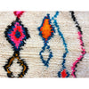 White Moroccan throw rug with details in blue, pink, orange, red, and black - Kantara | Moroccan Rugs