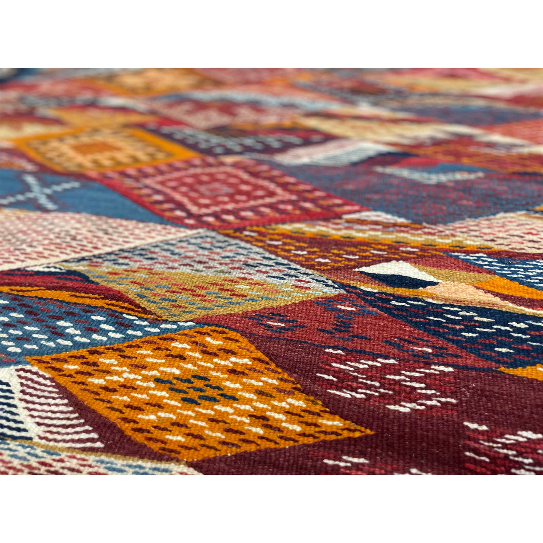 https://kantararugs.com/cdn/shop/products/R723.Detail.3.small-woven-details-in-orange-red-on-moroccan-kharita-berber-rug.jpg?v=1676126476