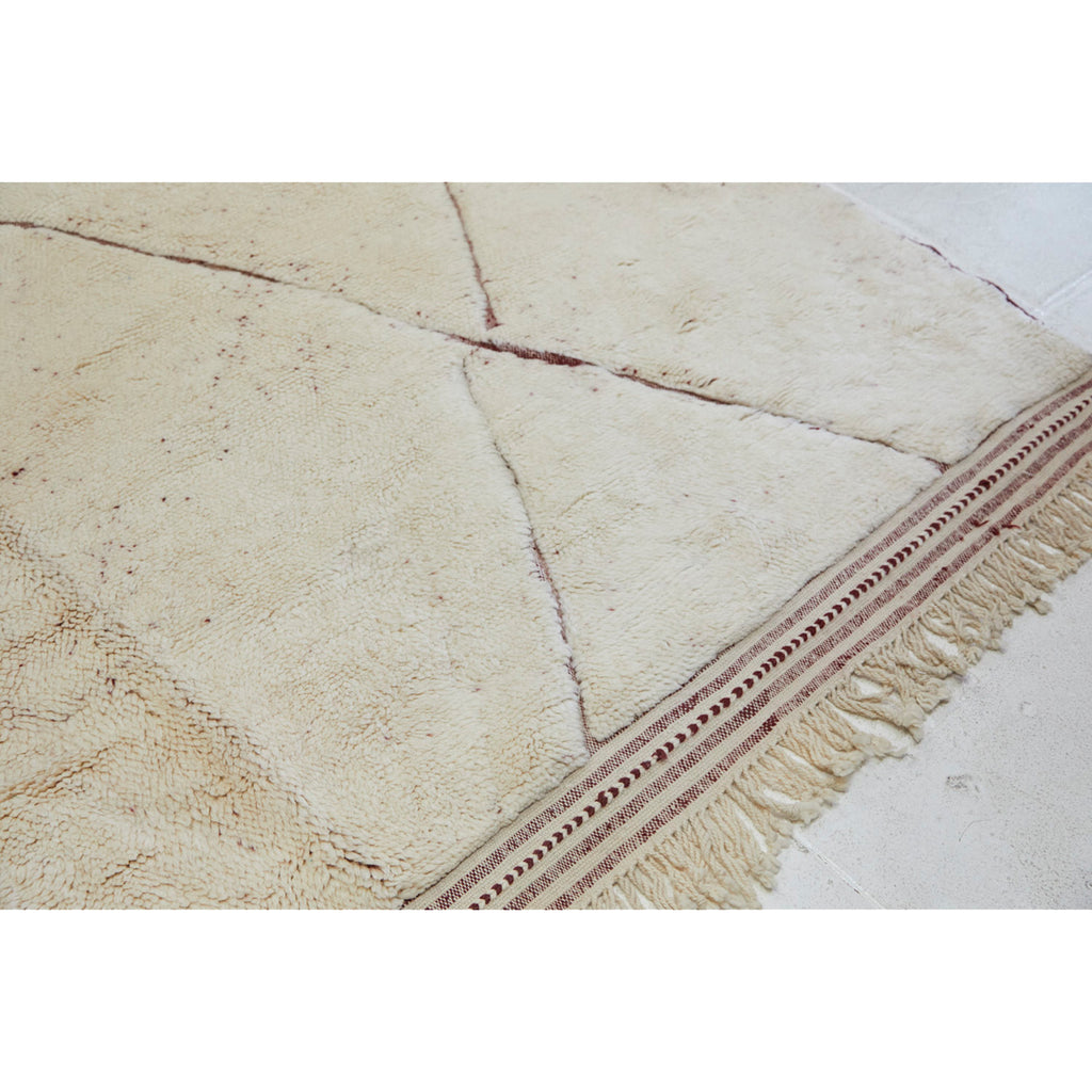 Braided fringe on oversized Moroccan beni mrirt rug in neutral and cranberry red tones  - Kantara | Moroccan Rugs